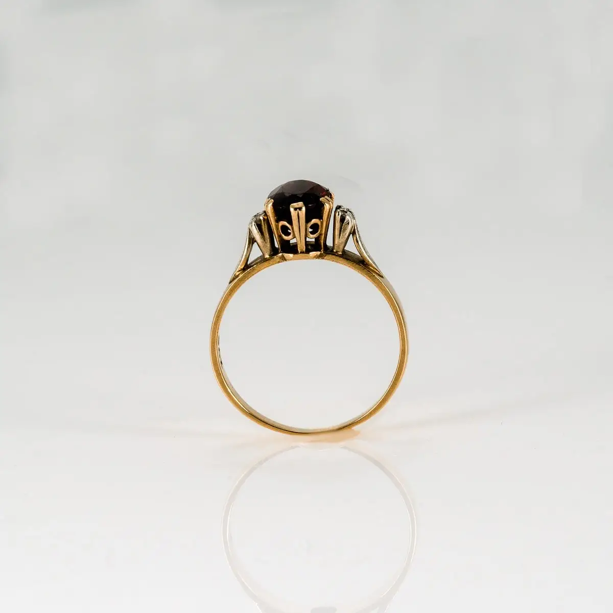 Garnet ring standing upright during claw rebuilding