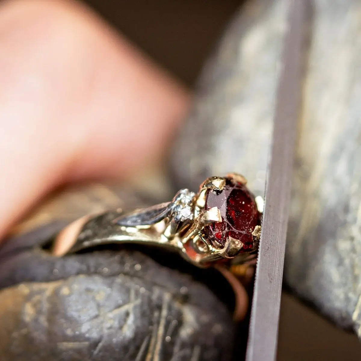 Hand-filing the new claws around the garnet