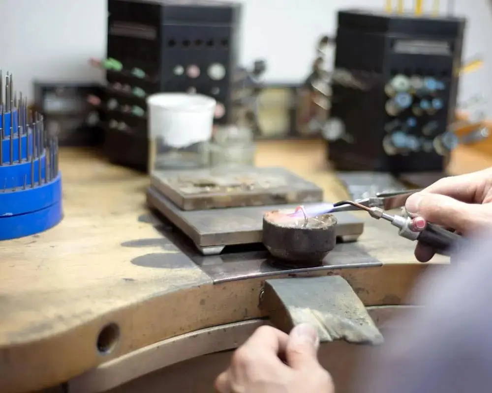 Jeweller resizing a platinum ring at the workshop bench
