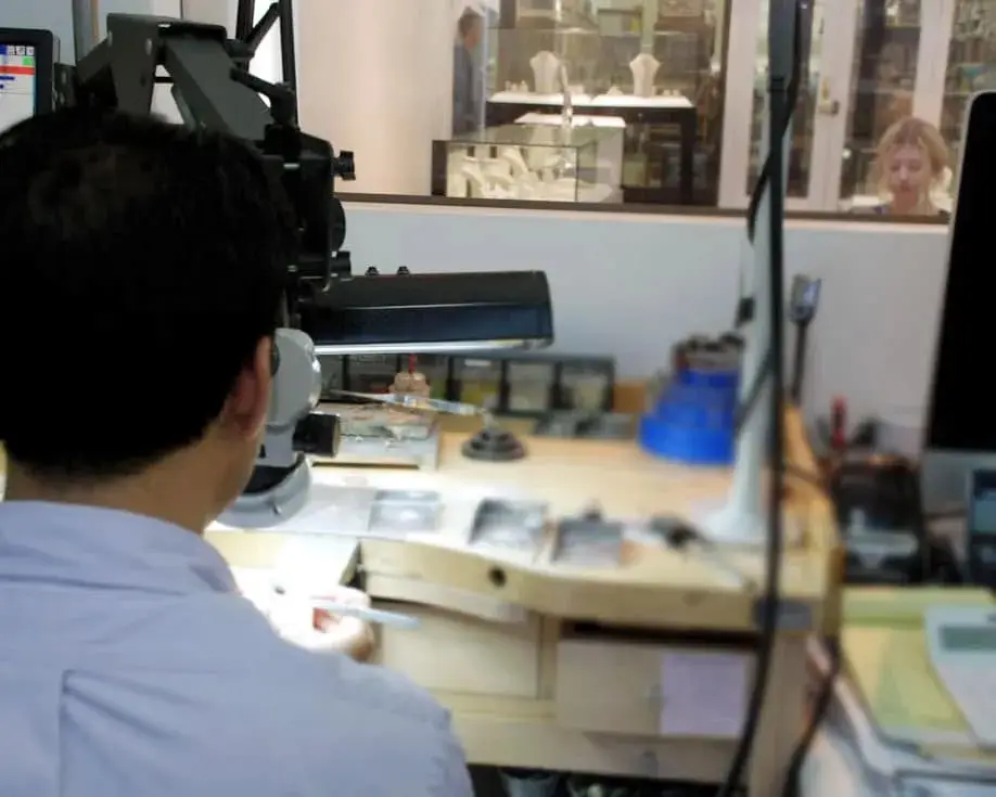 Client waiting in the showroom while her jewellery is repaired at the in-store workshop